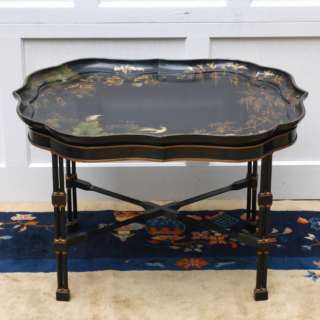 VICTORIAN BLACK JAPANNED TRAY TABLE: the shaped tray decorated with birds in a landscape, raised on a base with cluster-column legs joined by an X stretcher, the tray stamped "B Walton & Co. / Warranted", h. 21 w. 32 d. 24-1/2 in.