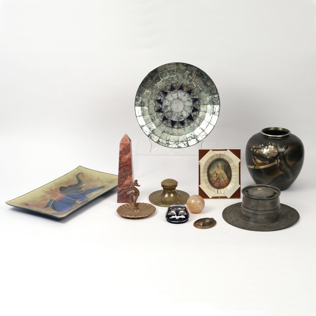 (11pc) DESK AND DECORATIVE ITEMS: Including a red marble obelisk (h. 8in.), a reverse painted glass tray decorated with an elephant (l.14 in x 8in.), a seahorse form brass ashtray, an inkwell/ pen holder, two glass paperweights, a Jap
