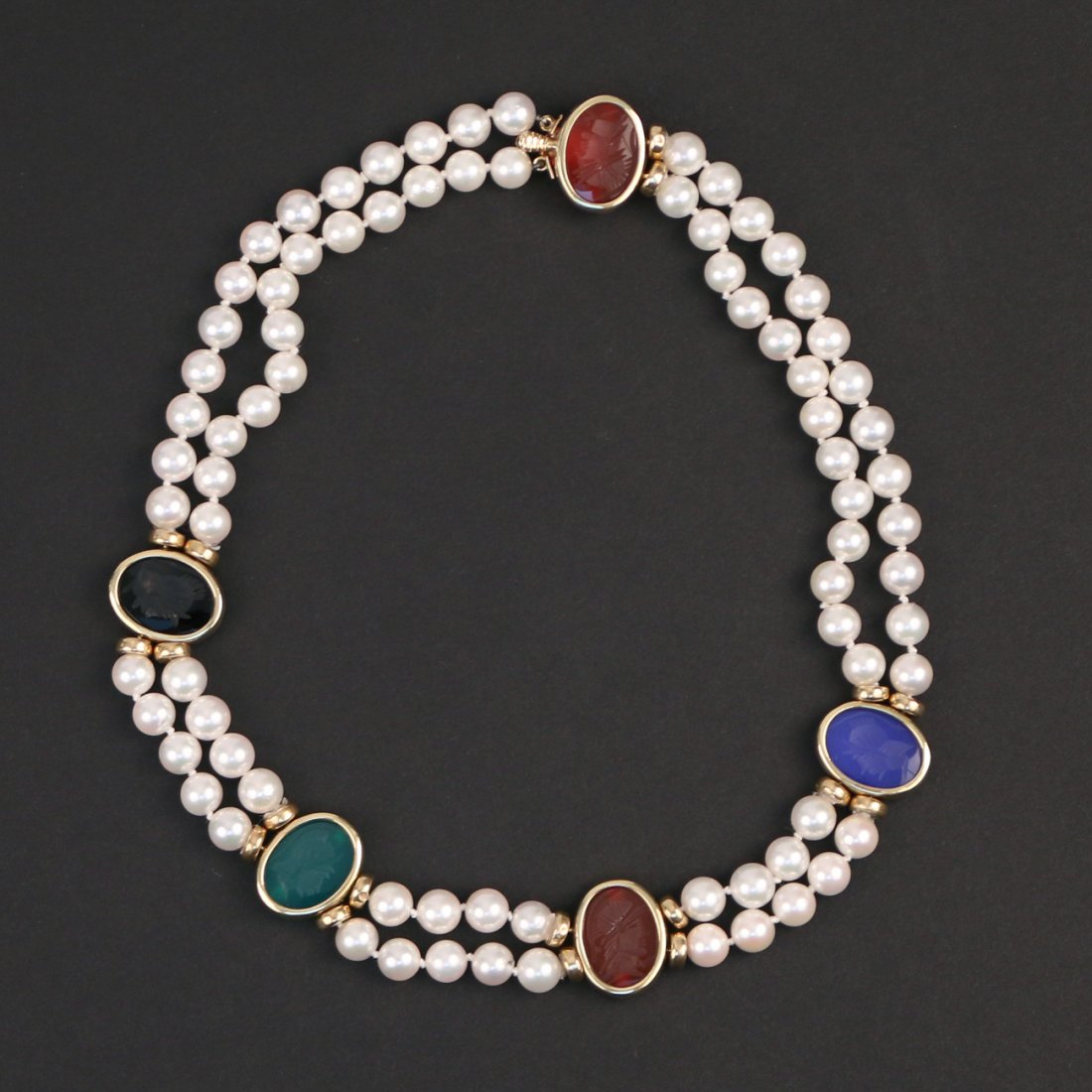 PEARL & INTAGLIO NECKLACE: Designed as a double strand of cultured pearls suspending five translucent intaglio roman soldier plaques with gold surrounds, l. 13.5 in.