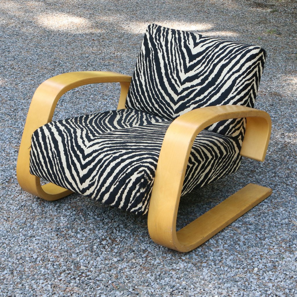 ALVO AALTAR TANK LOUNGE CHAIR: Bent birch plywood, the seat and seatback with zebra upholstery; h. 26 x w. 29-3/4 x d. 35 in.