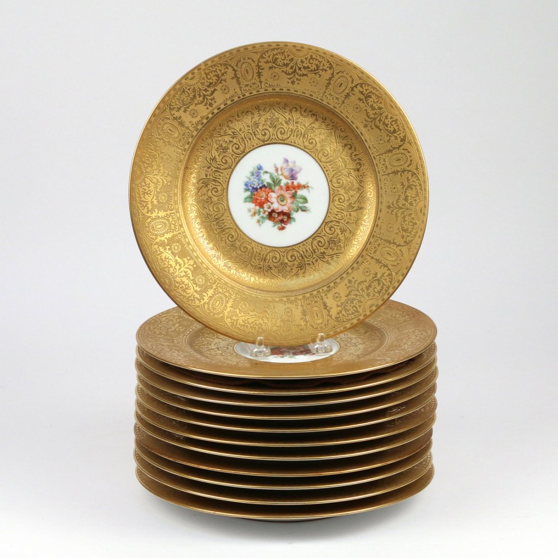 (12pc) ROYAL BAVARIAN SERVICE PLATES: early 20th Century, by Hutschenreuther, with raised gilt edges encircling floral reserves, d. 10-3/4 in.