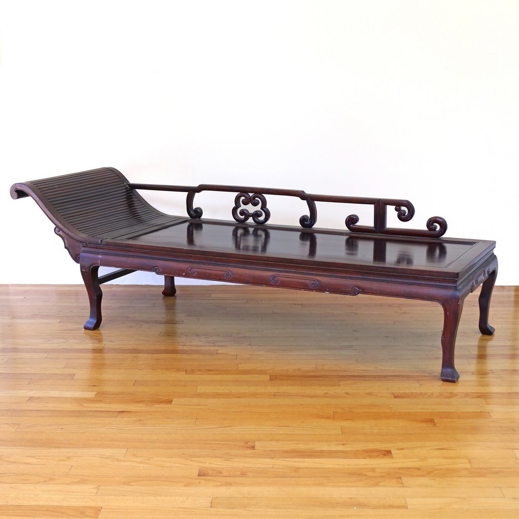 CHINESE CARVED HARDWOOD CHAISE: 19th/early 20th Century, with a single scrolled end and four animalistic legs, h. 23-1/2 w. 76 d. 25 in., Provenance: The Estate of the late Milton Gelfand, Pound Ridge, N.Y.