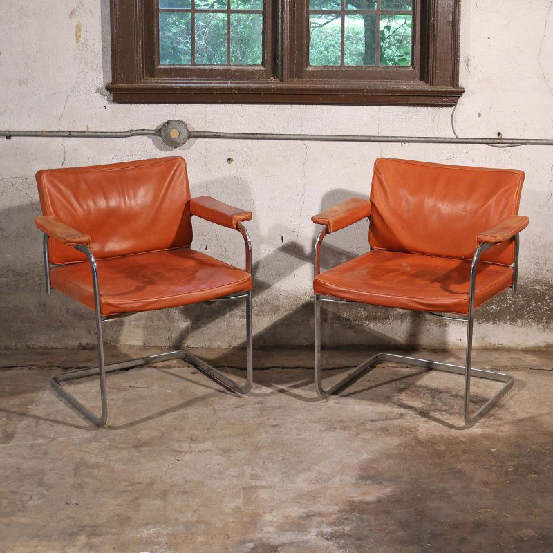 PAIR ROBERT HAUSSMANN / STENDIG ARMCHAIRS: chrome with orange leather seats, having Stendig labels, h. 30 w. 26 d. 23 in.