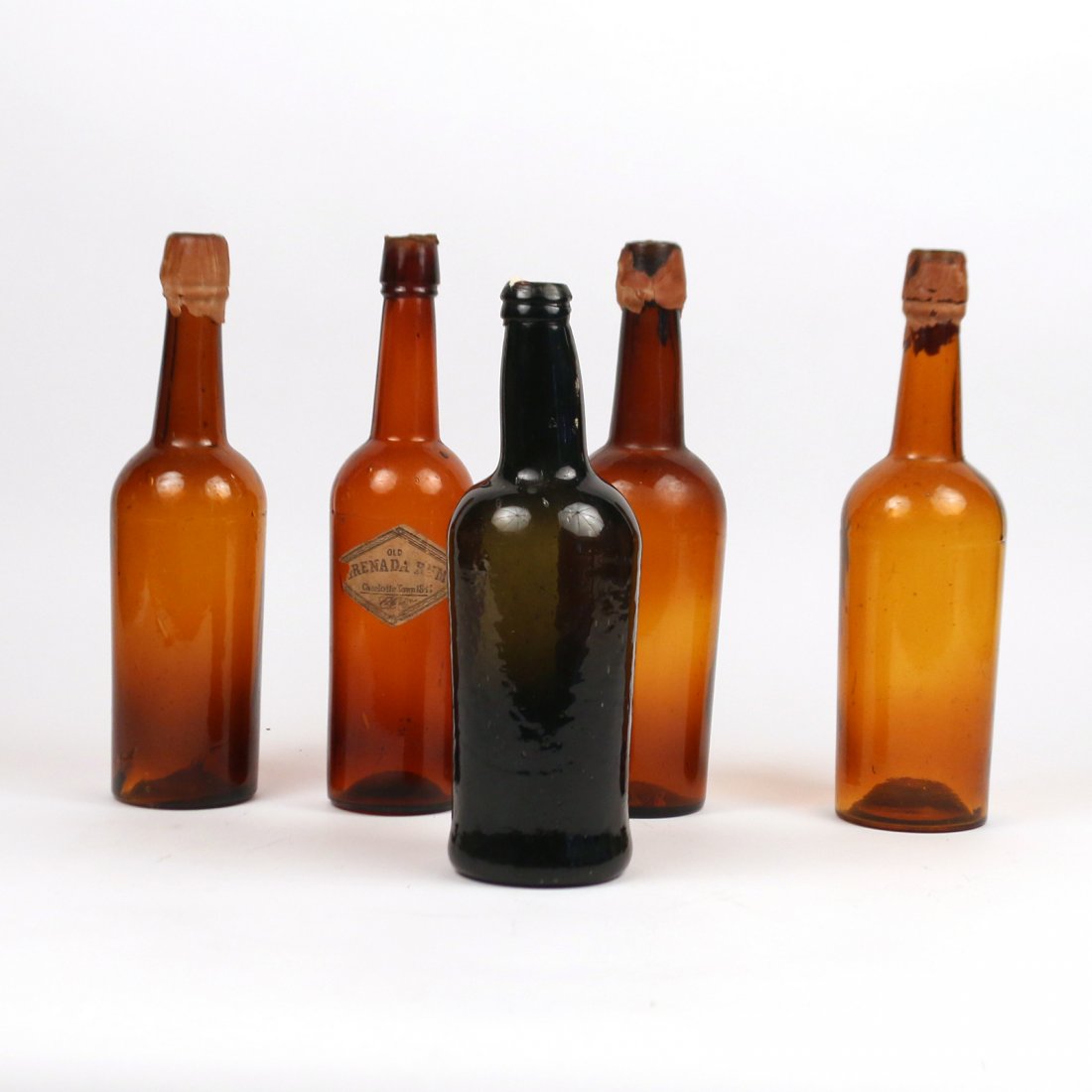 (5pc) ANTIQUE GLASS BOTTLES: four brown and one brownish green, h. 11-1/2 in.