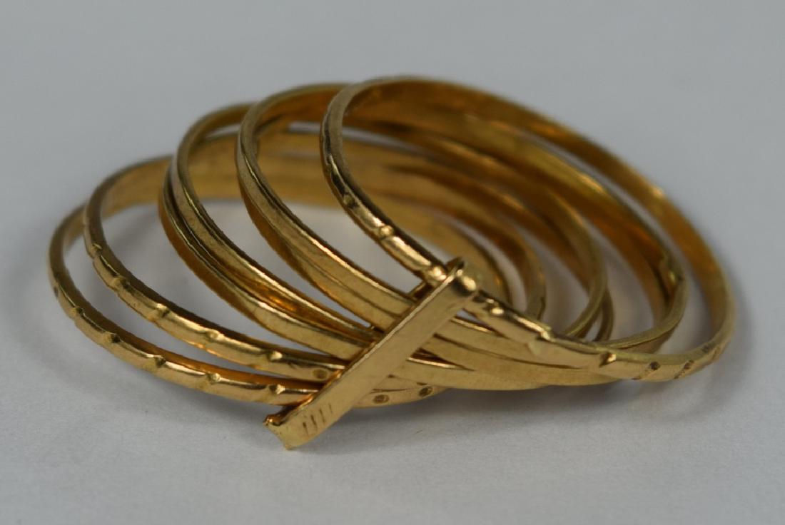 ITALIAN 18K GOLD 7 BAND LUCKY FIXED STACK RING: Unique with 7 bands, 4 plain & 3 patterned, held together with vertical bar. Ring size 7. No apparent marking, tested 18K. Measures 1 3/8" W on finger. Weighs 3.6g. U.S. SHIPPING $15 + INSURANCE.