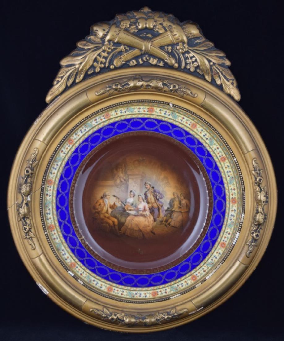ROYAL VIENNA PORCELAIN FRIEDRICH SIMON PLATE: Antique, early 20th century Royal Vienna Austrian plate blank decorated by Friedrich Simon, decorating studio in Carlsbad, Bohemia. Depicting a musical gathering, instruments, sheet music, singing. Mo
