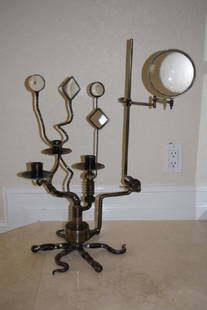 BOB BELLIO (AMER., 20TH C) CANDELABRA SCULPTURE: Sculptural found steel three light candelabra with rotating glasss lenses. Purchased from and with 1996 receipt for over $1,200 from Richard Himmel Antiques & Decorative Furniture, Chicago, Il.