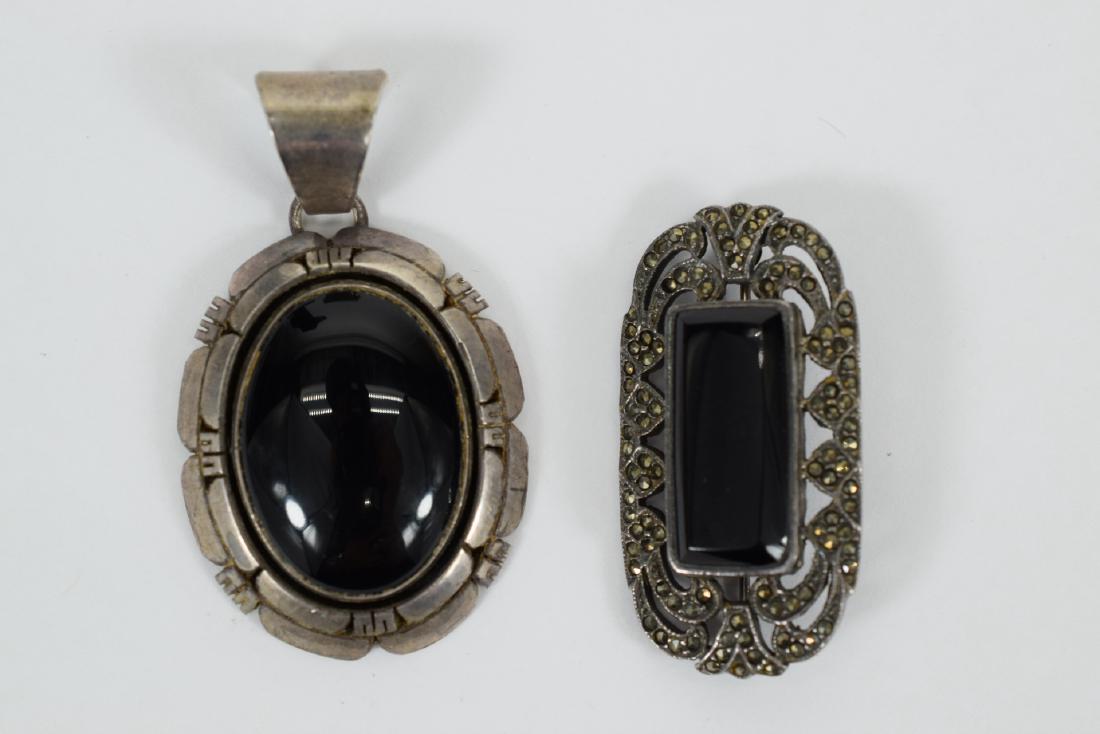 STERLING SILVER ONYX PENDANT AND MARCASITE PIN: Navajo sterling silver and onyx heavy pendant hallmarked 925 and signed BILLIE. Marcasite brooch / pin hallmarked 925. Pendant measures 2-1/4” (including bail) and brooch measures 1-3/4” L