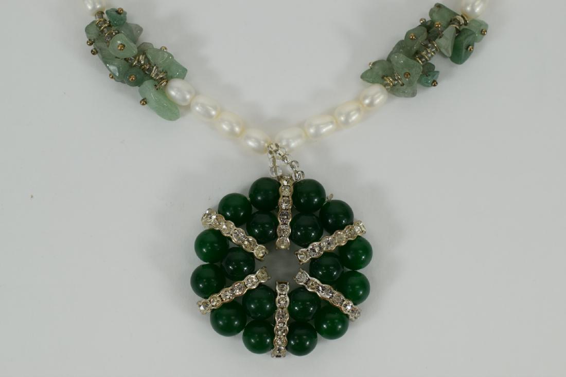 FRESH WATER PEARL & JADE NECKLACE: White freshwater pearl necklace with four light green jadeite clusters on strand, holding an emerald green jadeite beaded wreath pendant with six rows of white tourmaline gemstones. Measures 20”