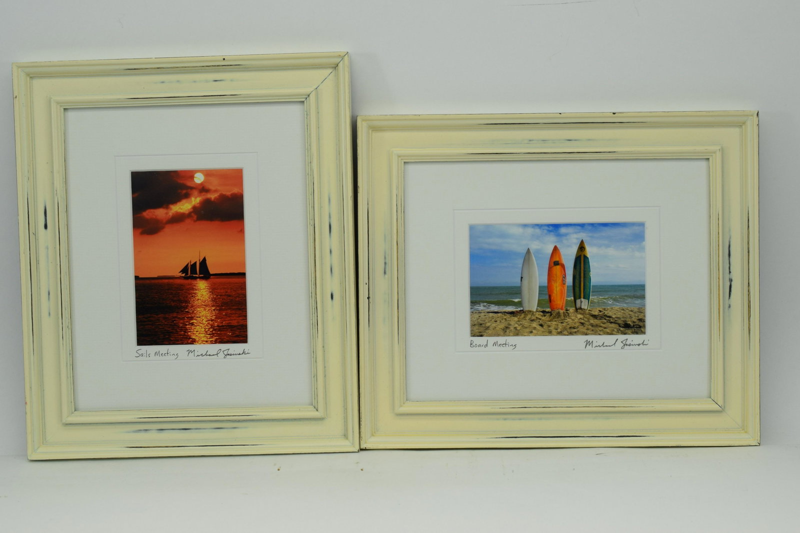 PAIR MICHAEL JASINSKI BROS SIGNED PHOTO PRINTS: One depicting 3 surf boards stuck in the sand at the beach, titled "Board Meeting". The other a sailboat ship in in the horizon of a sunset, titled "Sails Meeting". Each titled and signed by hand in p