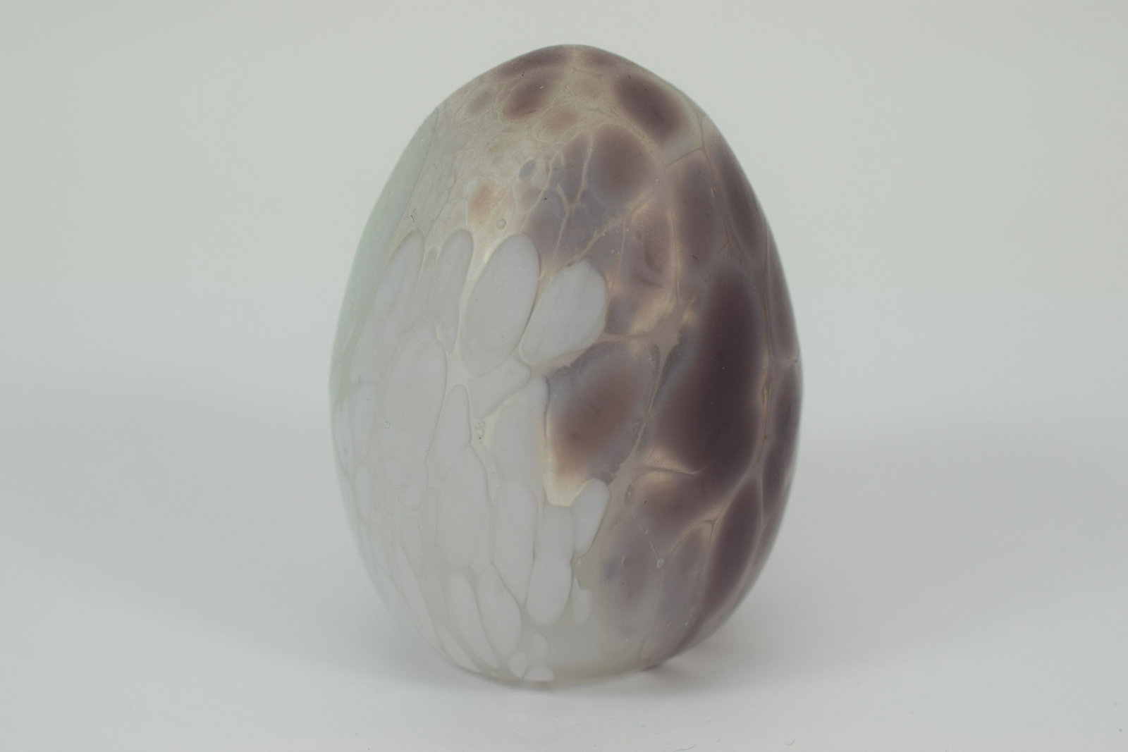 DELICATE ART GLASS EGG ORNAMENT: Hand painted purple and white enamel-like art glass fragile egg having a hollowed inside. Possibly GES or Mount St. Helen volcanic ash design. Measures approximately 2-5/8" H x 2" Diameter. Weighs 1.8