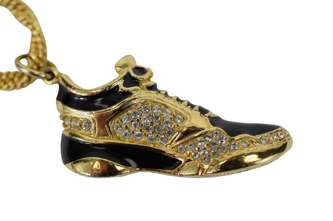 SWAROVSKI CRYSTAL GOLD TONE SNEAKER NECKLACE: Hallmarked with a copyright symbol and a "Swan" to the bottom of sneaker (1-1/2" L x 7/8" W). Gold tone rope necklace measures 32" L. Total weight 54.3g. U.S. SHIPPING $15 + INSURANCE.