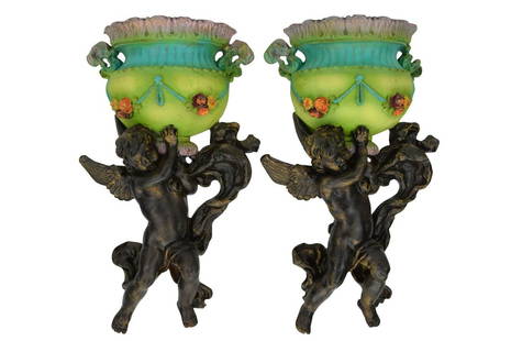 MICHAL NEGRIN CHERUB & FLOWER POT WALL HANGINGS: A pair of rare Michal Negrin wall hanging sconces depicting a cherub carrying a flower pot. Lacquer over composite / faux wood. Each measure approximately 14-1/4" L x 7-1/4" W x 3-1/4" D. Each weigh