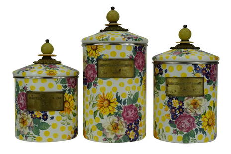 MACKENZIE-CHILDS BUTTERCUP FLOWER CANISTERS SET: Set of three (3) MacKenzie-Childs "Buttercup" (rare, retired pattern) enamel lidded canisters. Pattern of yellow polka dots with flowers motif. The largest lidded canister measures 10" H (including
