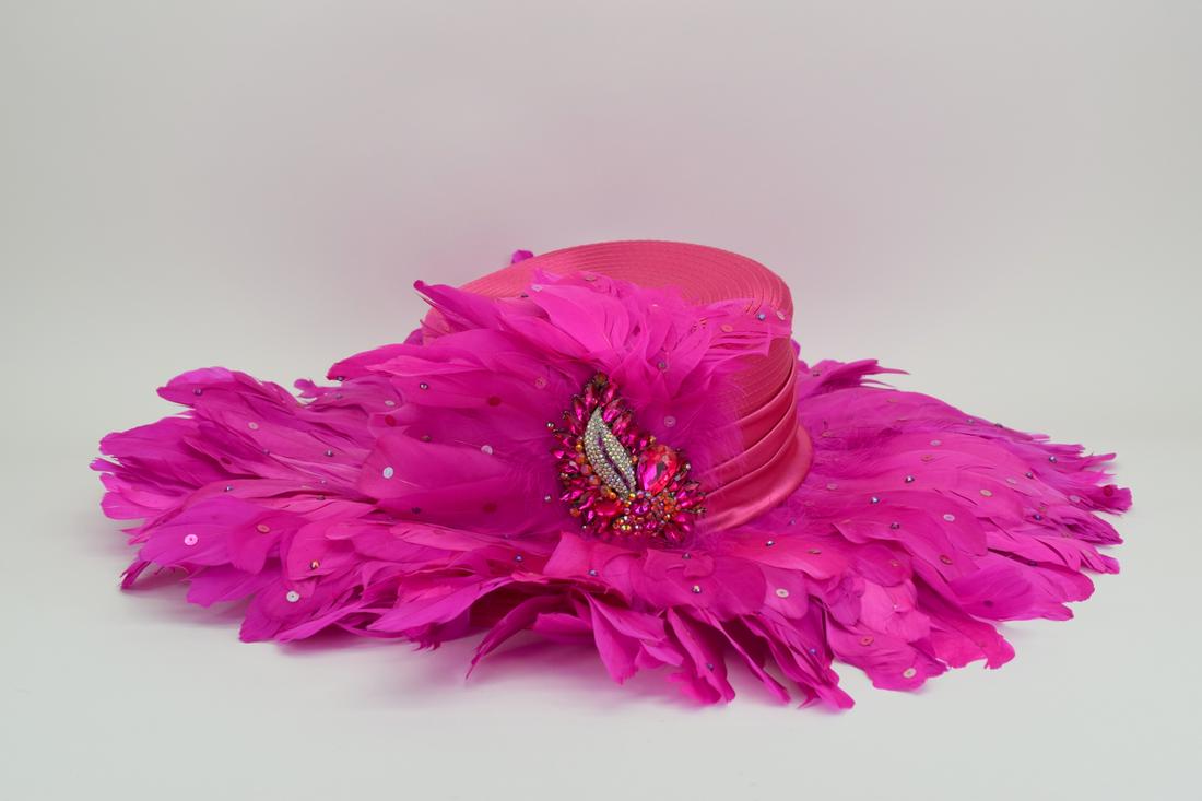 WHITTALL & SHON PINK FEATHER KENTUCKY DERBY HAT: Derby hat with pink feathers and sequins, and a rhinestone encrusted feather charm (4-1/2" L x 2-3/4" W). Rim of hat measures 16-1/8" Diameter (with feathers 23" Diameter). THIRD PARTY SHIPPING REQUIR