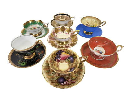 PORCELAIN TEA CUP & SAUCER COLLECTION 7 SETS: Two (2) Royal Stafford England; one "La Vigne D'or 1845"and one "Poinsettia 1845, two (2) Ansley England, two (2) Shelley England, and one (1) Paragon England. All seven sets come on/with display