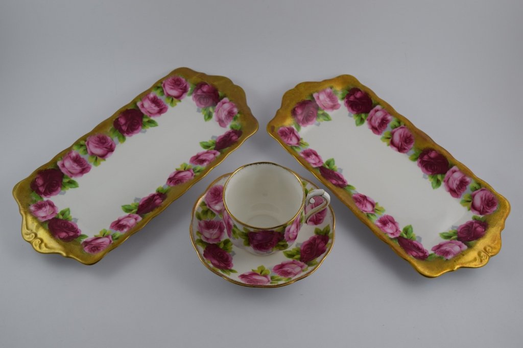 ROYAL ALBERT FLORAL TEACUP & SAUCER W/ TRAYS: 1 teacup & saucer with 2 matching platters. Both hand painted with roses and gold. Cup & saucer measure 5 1/2" (13.9cm) in diameter x 3" (7.6cm) high. Trays each measure 11" (27.9cm) long x 5" (12.7cm