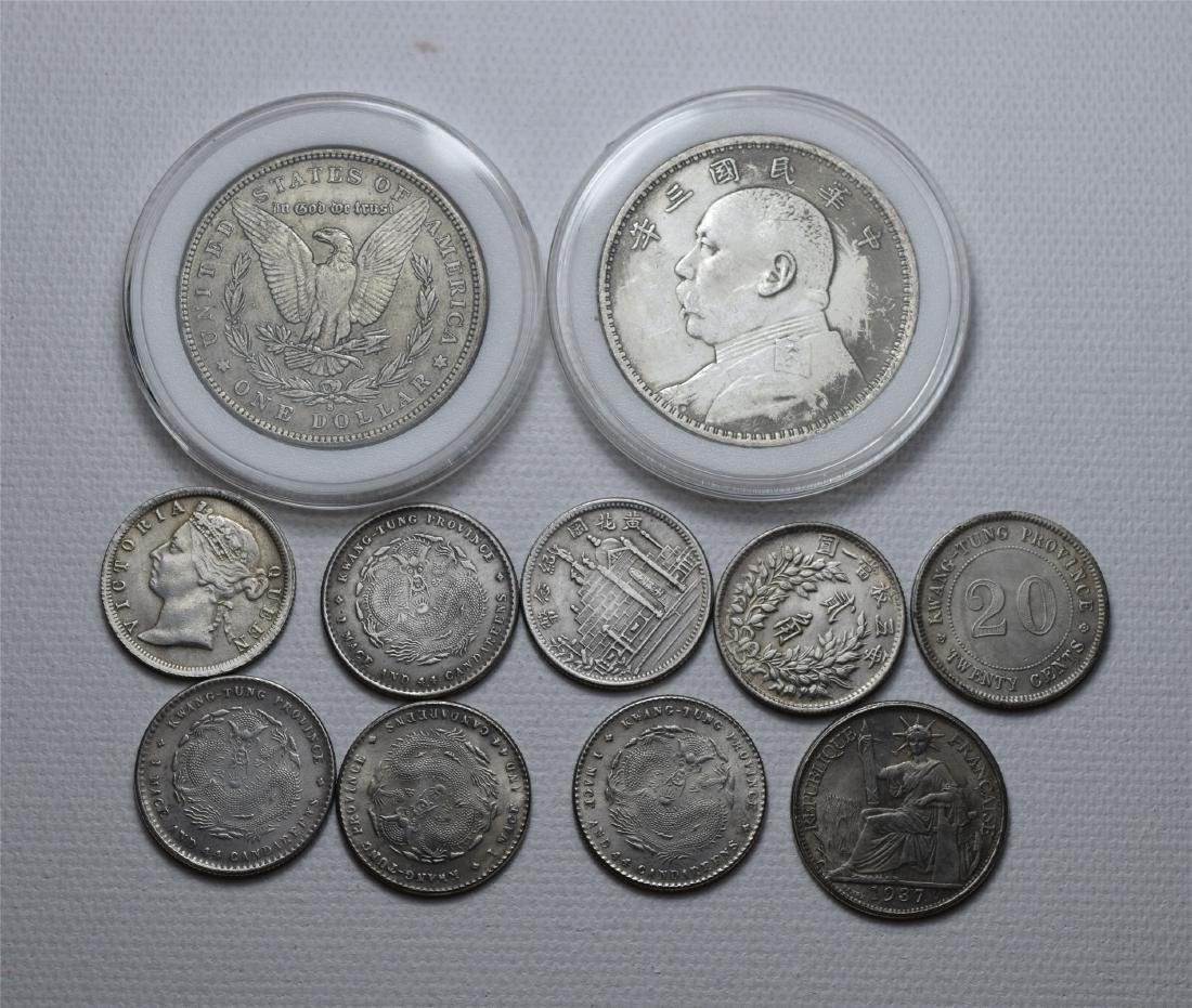 ELEVEEN CHINESE SILVER COINS (1 of 2)
