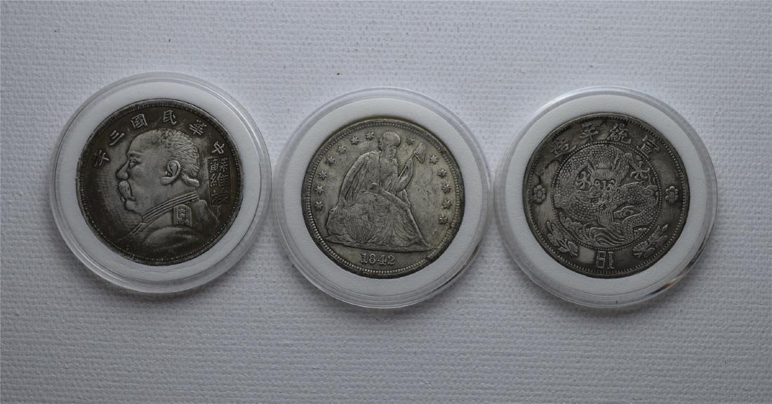 THREE CHINESE SILVER DOLLAR COINS (1 of 2)