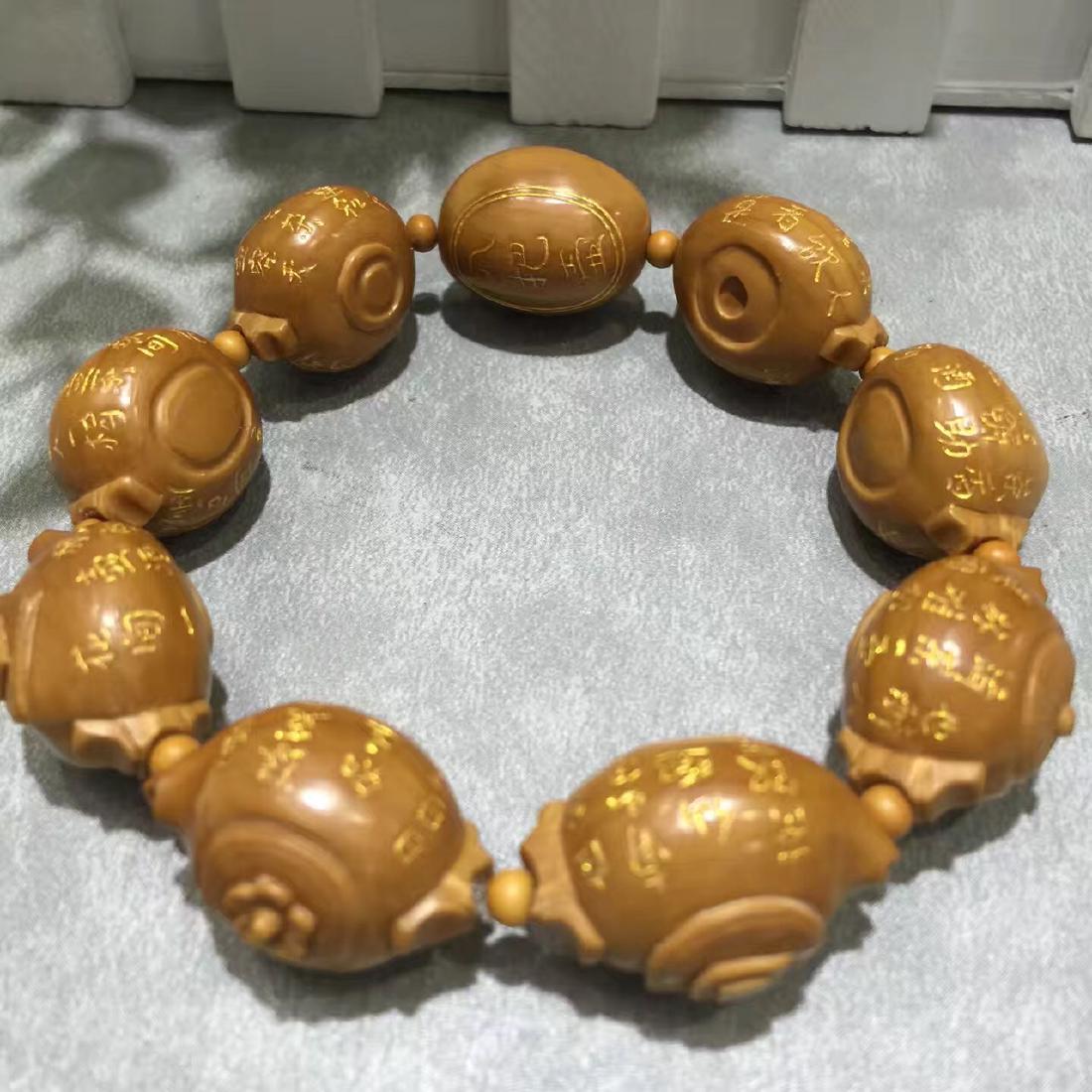 NINE OLIVE NUT CARVED TEA POT BEADS WAIST LACE: NINE OLIVE NUT CARVED TEA POT BEADS WAIST LACE. Each bead L. 2.35 cm. W. 1.82 cm. Domestic shipping $10 and oversea $20. Combined shipping available.