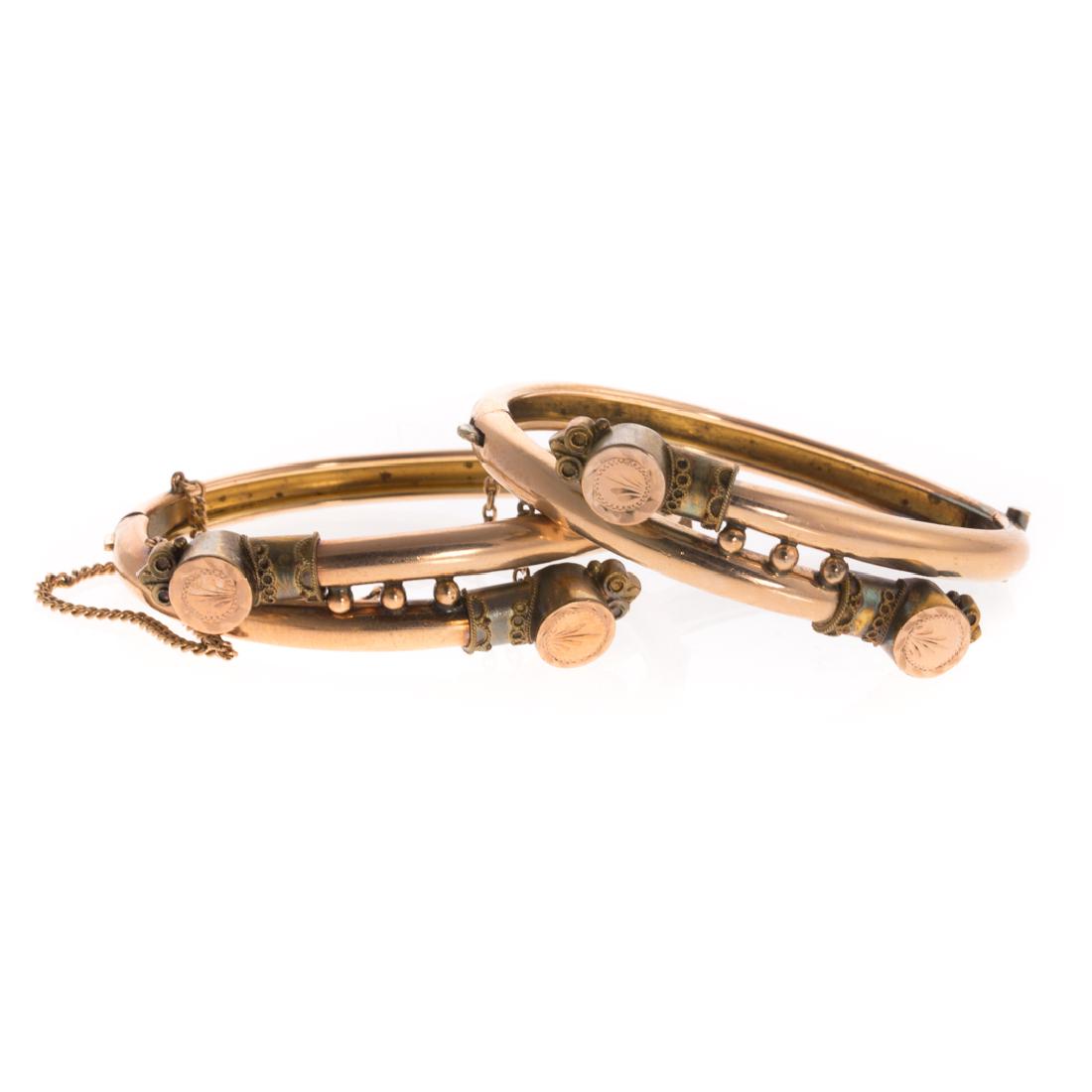 A Pair of Victorian Wedding Bracelets: Gilt, tubular bracelets with engraved and rope detailing, hinged oval shaped, safety chain, 2.25 in. L, 33 grams tw