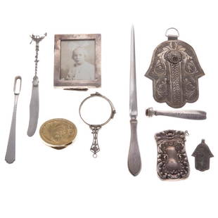 Collection of silver personal items: 8 American and Continental items, including: Tiffany rotary phone dialer, pince-nez glasses (one lense cracked), 2 letter openers, oval pill box, vesta case, traveling toothbrush frame, and a small ph