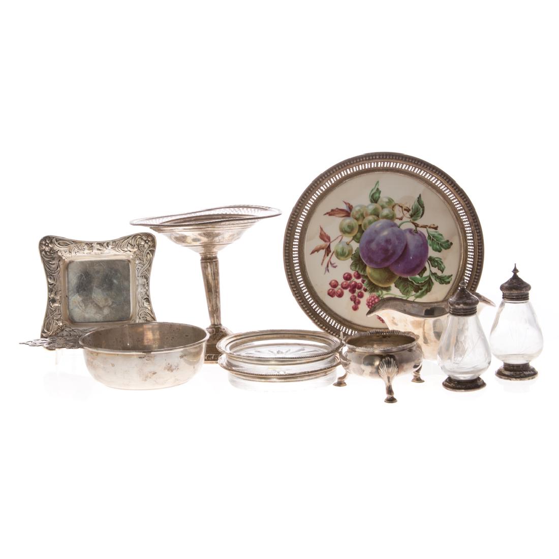 Assorted sterling and weighted sterling tableware: 10 items, comprising: footed bowl, pair of sterling rimmed bottle coasters, weighted compote, sterling rimmed porcelain wine coaster, etched glass and sterling salt & pepper set, Georgian trencher sal