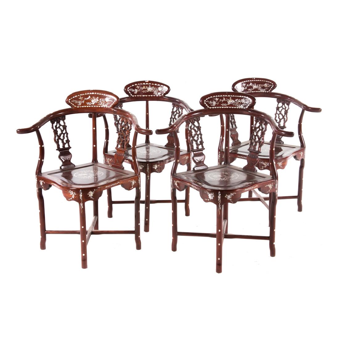 Four Vietnamese carved hardwood yoke-back chairs: 20th century; pierced vertical back splats, plank seats, four legs connected by X-form stretchers, mother-of-peal inlay overall, 33 7/8 in. H., 23 in. W., 21 1/2 in. D.