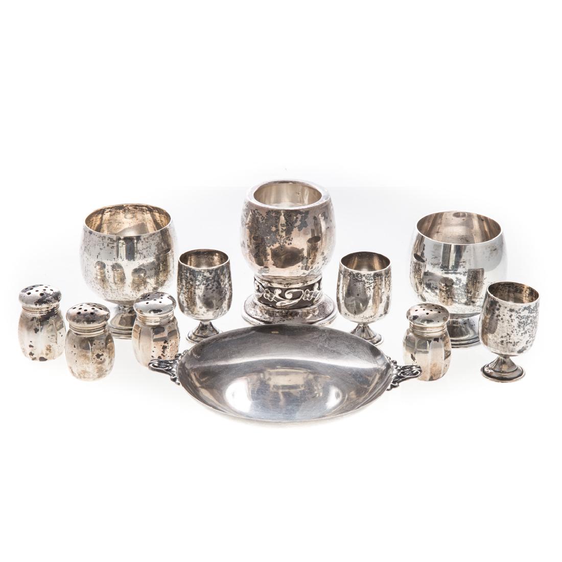 A collection of American sterling tableware: 11 pieces, including: 4 individual salts, 2 large cordials, 3 small cordials, toothpick holder, and a wine coaster; 12.65 ozt.