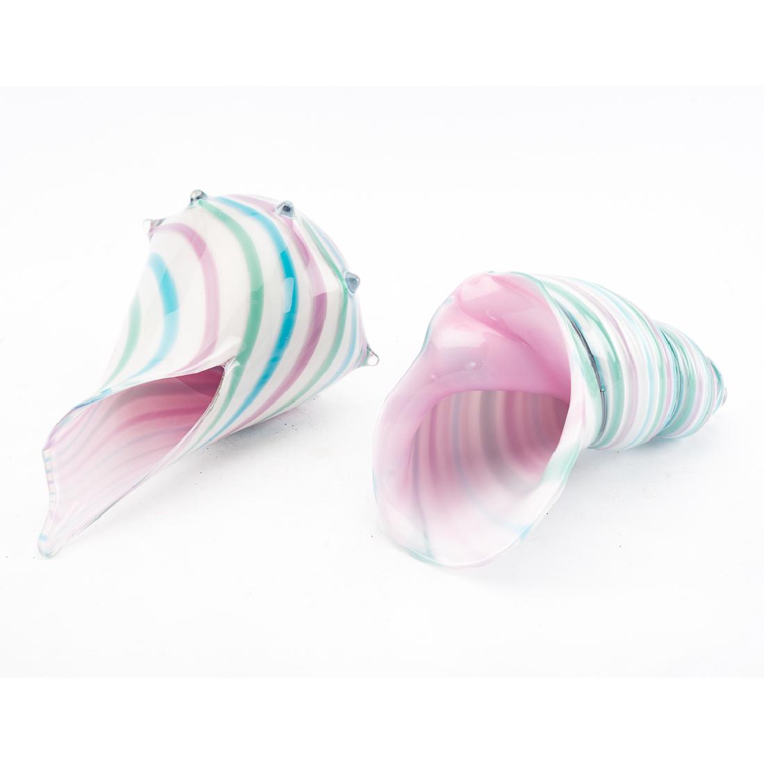 Two large cased art glass sea shells: whelk type shell with multi color swirl design, signed "Geoffrey Beetem 1990," 12 in. L. and similar unsigned spiral shell,10 in. L.