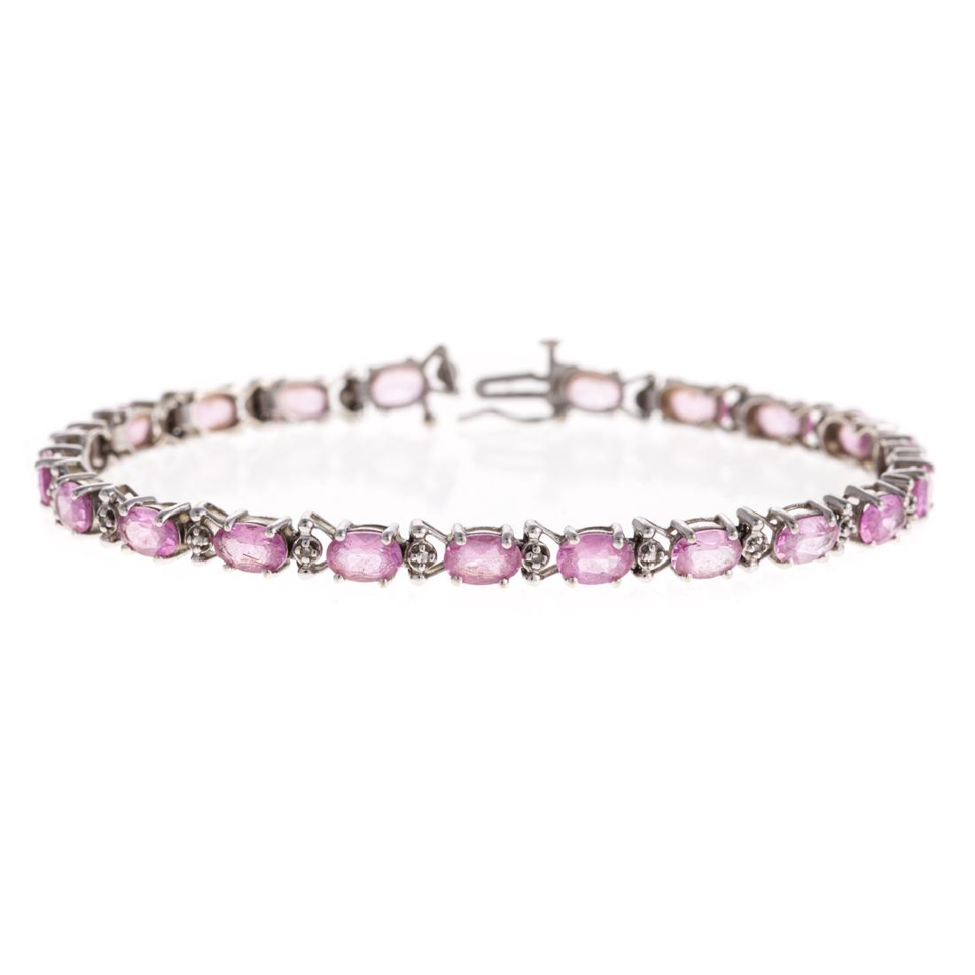 A Lady's Pink Quartz & Diamond Line Bracelet: 10K white gold faceted pink quartz with diamond link, box clasp with figure 8 clasp, 7.5 in. L, 9.1 grams