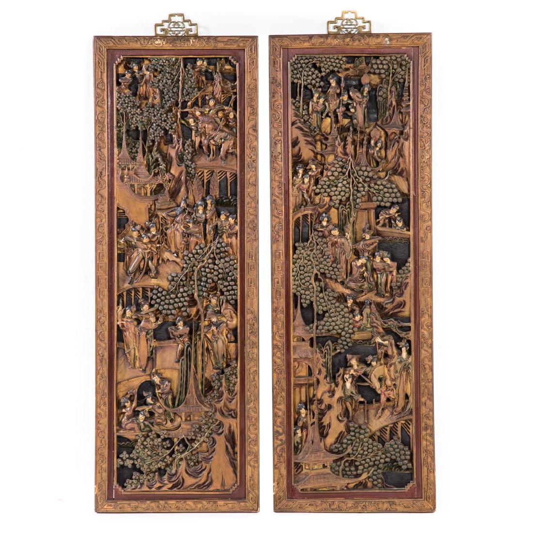 Pr. Chinese carved polychromed wood relief panels: late 19th/early 20th century; highly detailed panels, each depicting human figures and trees among tiered village scene, each 41 x 14 in.; Probably part of bed or building facade entrance