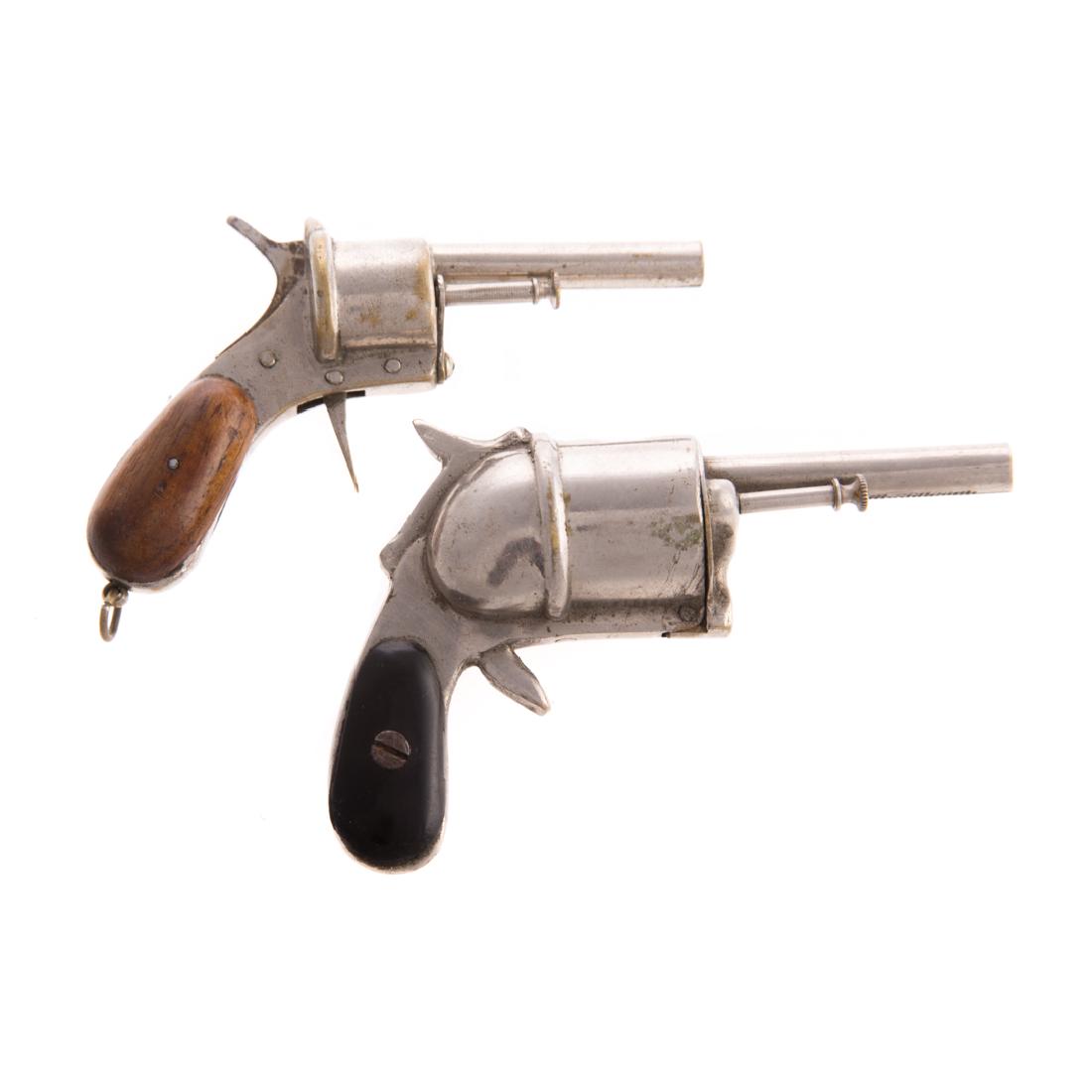 Two nickel-plated pistol lighters: late 19th century; each nickel-plated brass, one with walnut handle grips, other ebonized wood handle grips, 3 1/2 to 4 in. L.