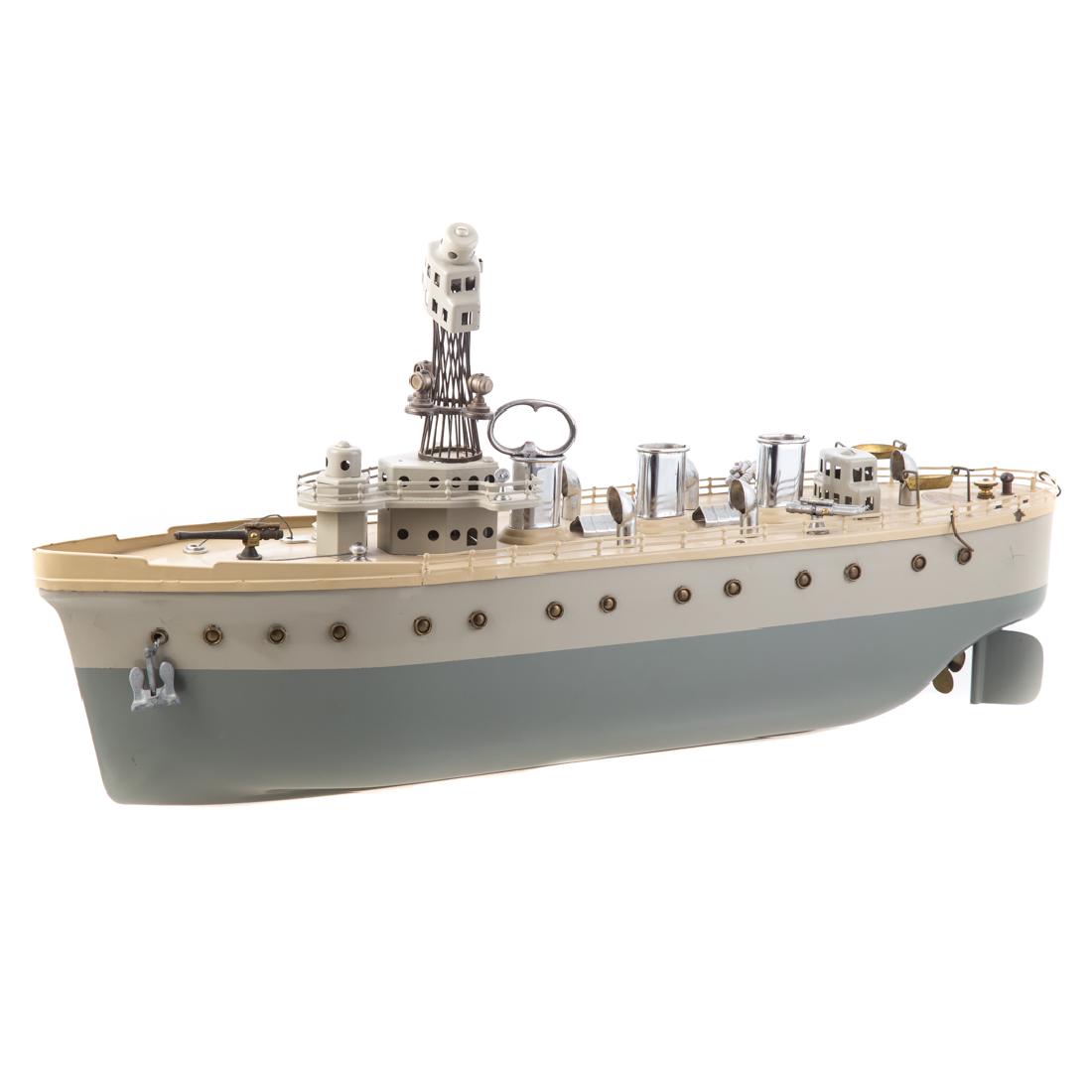 Orkin painted pressed steel torpedo boat: circa 1920s; triple stacks, conning tower, twin torpedo launches and bow gun, 24 in. L.