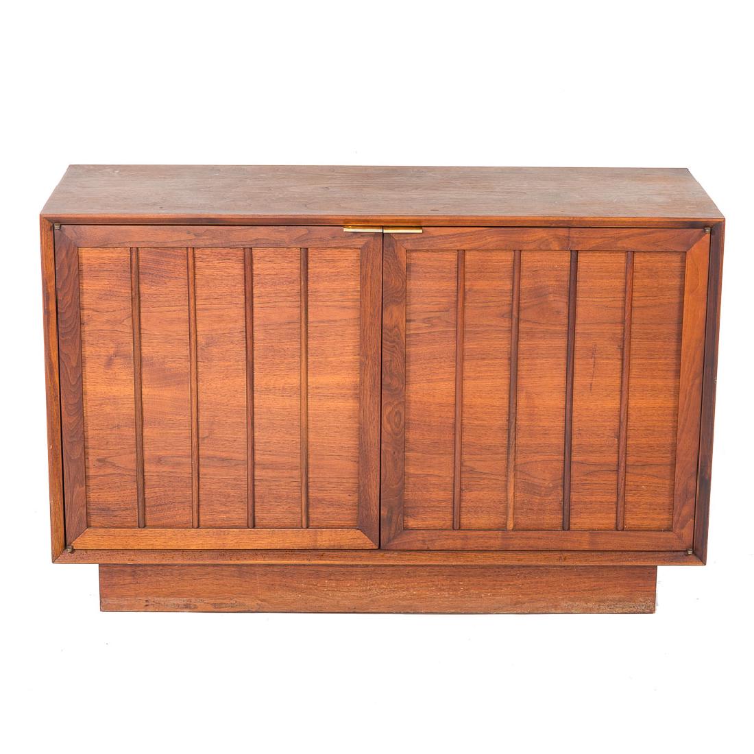 Mid-Century Modern teakwood credenza: mid-20th century; flat top, double compartments with drawer and shelves enclosed by solid reeded panel doors, recessed platform base, 28 in. H., 44 in. W., 16 in. D.