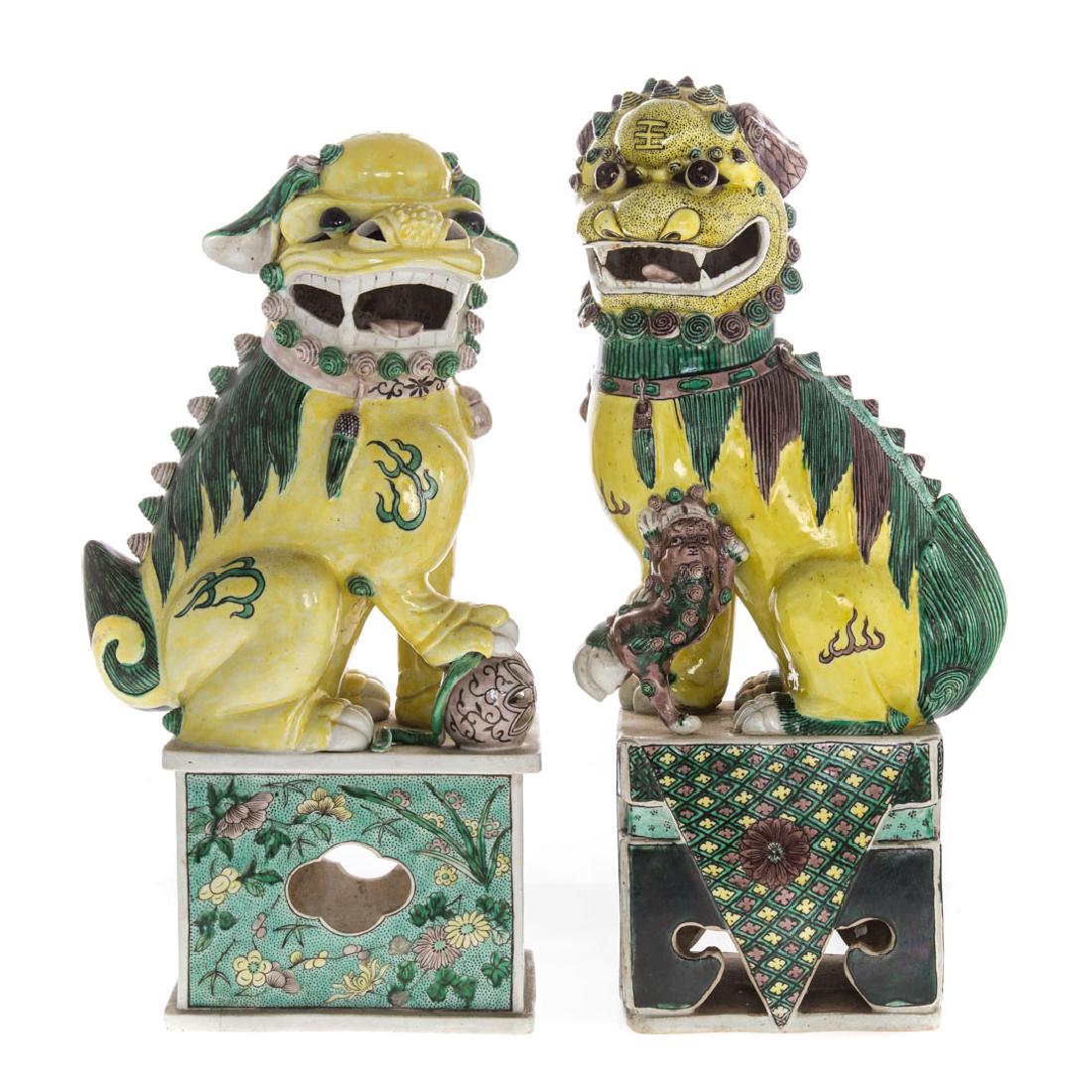 2 Chinese Export Famille Verte porcelain foo dogs: second half-19th century; male and female dogs on altar style base, 17 1/2 and 17 in. H.