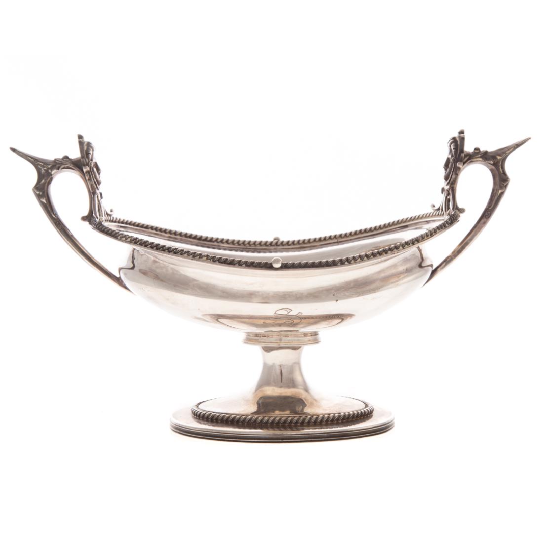Wood & Hughes silver centerbowl: mid-19th century, 900 silver standard, oval with rope twist border, on a conforming foot, portrait medallion handles, 6 1/2 in. H, 11 1/2 in. L., 19.15 ozt.