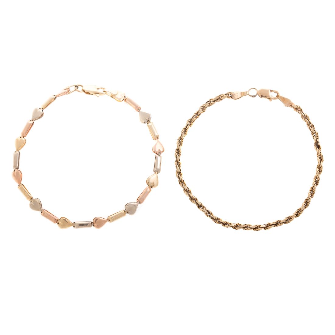 A Pair of Lady's Gold Chain Bracelets: 1) 14K yellow, rose and white gold heart link bracelet, high polish finish, lobster clasp, 7.25 in. L and 2) 14K yellow gold rop chain bracelet with lobster clasp, 7 in. L, 10 grams tw