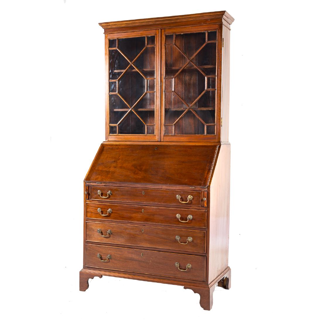 George III mahogany secretary bookcase: late 18th century; upper with molded cornice, compartment with shelves enclosed by glazed panel doors, fitted compartment beneath with drawers and pigeon holes enclosed by slant front lid, four gradua