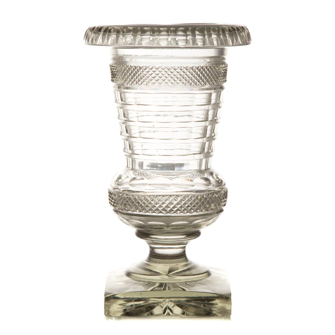 Large Anglo-Irish cut glass urn: mid-19th century; faceted and banded cut urn on square base, 12 in. H., 7 in. Diam.; Estate of Dr. William M. King, Fort Lauderdale, FL.