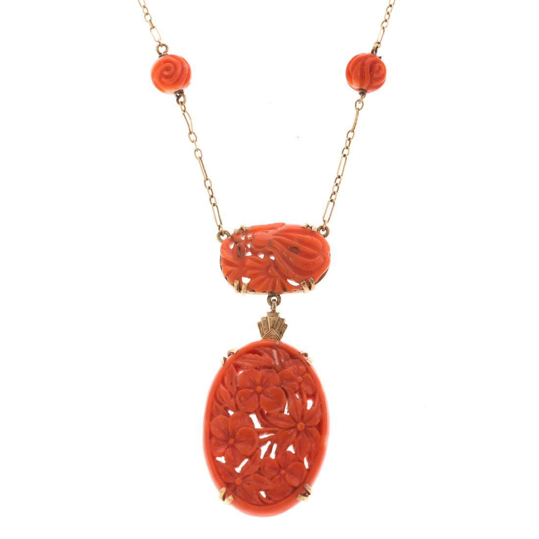 A Vintage Carved Coral Necklace in 14K: 14K yellow gold necklace featuring 2 very fine hand carved oval coral center pendants with carved coral beads, open oval link chain with spring ring clasp, 16 in. L, 10 grams
