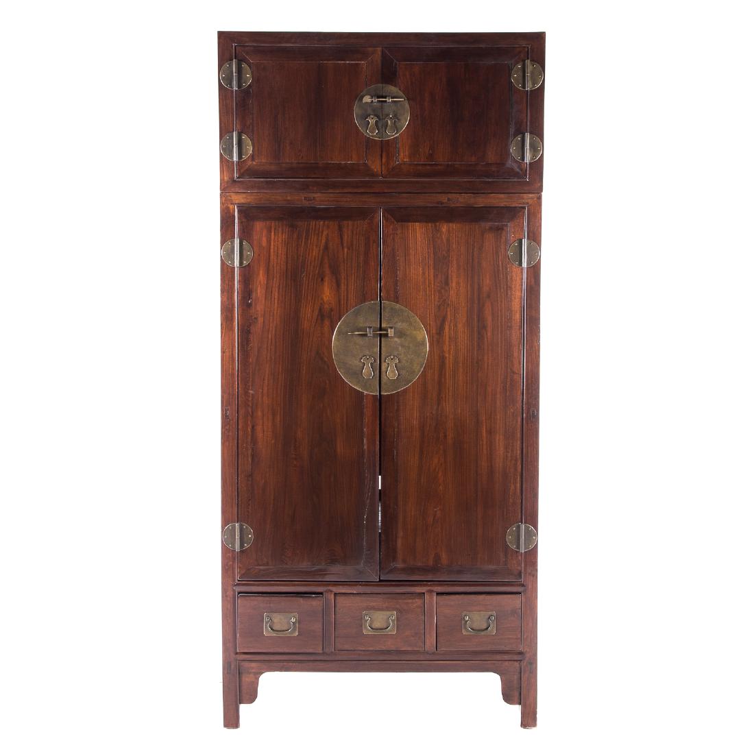 Chinese elm wood & brass cabinet: 20th century; two parts, upper with flat top, compartment enclosed by two solid panel doors, over compartment with shelving and drawers enclosed by solid panel doors over three drawers, square legs, 8