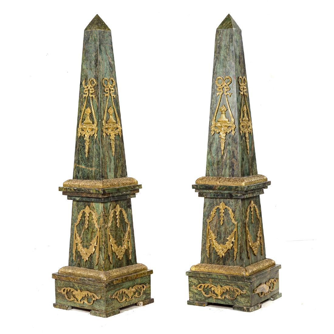 Pair Empire style brass mounded marble obelisks: 20thc century; green marble pyramidal obelisks, polished brass mounts, pedestal base, 56 in. H., 14 in. W., 13 3/8 in. D.