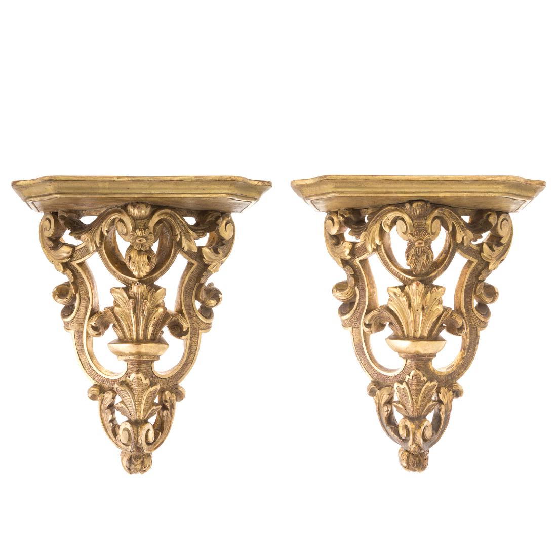 Pair Rococo style giltwood wall brackets: early 20th century; elaborately carved scroll and acanthus supports with shaped shelf top, 18 in. H., 14 in. W.