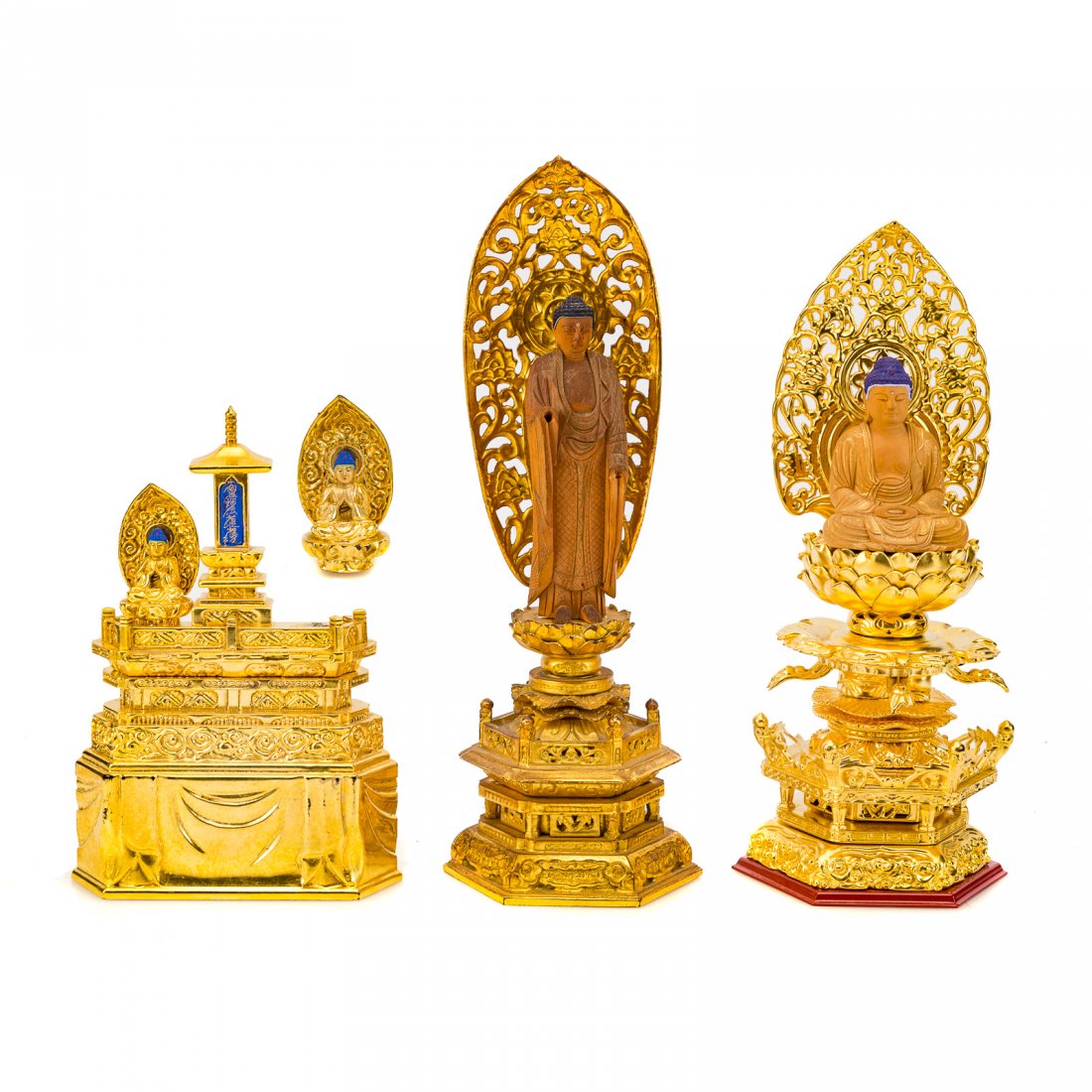 Three Chinese carved /gilt wood Buddhist shrines: two shrines with carved and gilt accented sandal wood figures of Buddha, with gilt haloes on elaborate gilt wood architectural bases and separate shrine with gilt and lacquered wood altar with two min