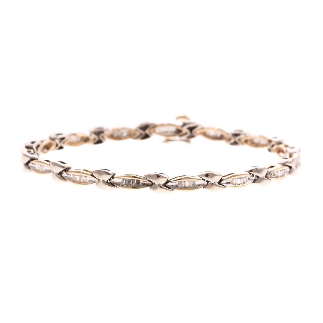 A Ladies 14K Two Tone Diamond Link Bracelet: 14K yellow and white gold bracelet featuring baguette cut diamonds channel set in marquise shape lings, hidden box clasp with figure 8 safety, 7 in. L, 10.6 grams