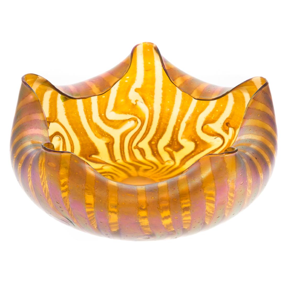Art Nouveau Style Iridescent Art Glass Bowl: hand-blown amber glass bowl with folded rim and bands of contrasting iridescence; no apparent maker's mark; 4 1/2 in. H., 10 in. Diam.
