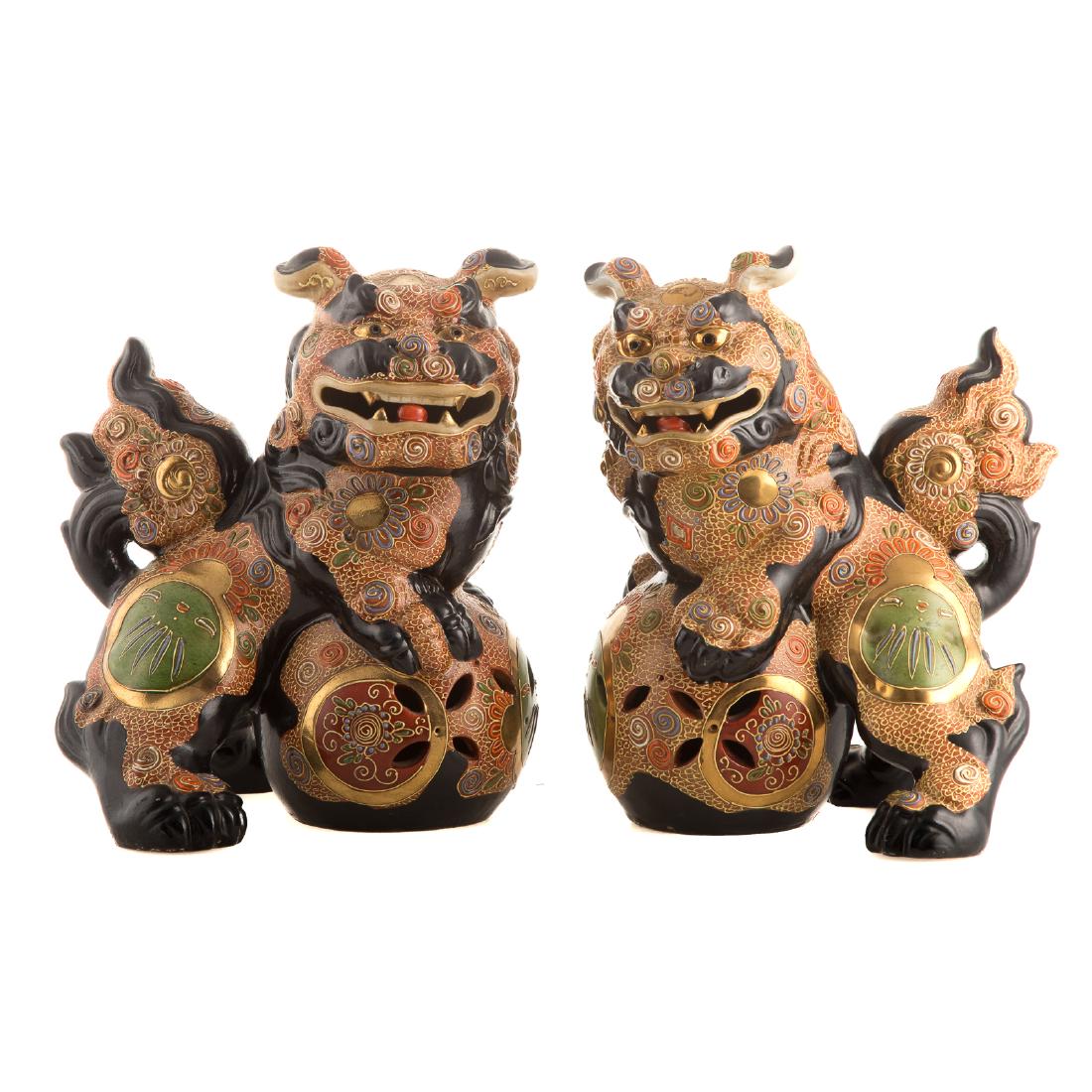 Pair Japanese Satsuma Foo Dogs: circa 1920s; each dog with front paws resting on sphere, 11 in. H.