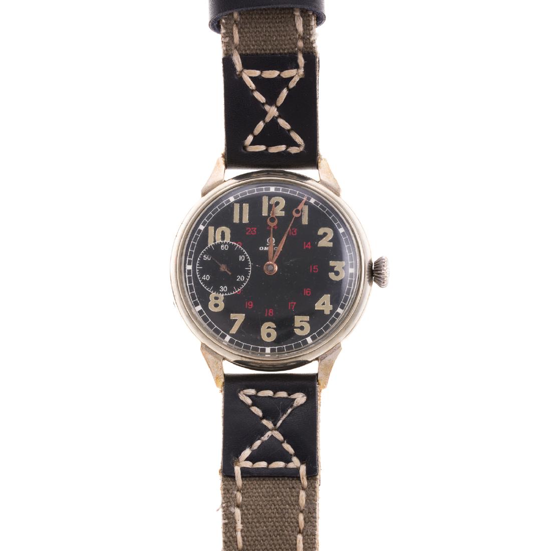 A Gentlemen's Omega Military Watch c. 1930's: Stainless steel, military style, 43mm, mechanical movement, second hand sub dial, 24 hour clock, canvas and leather stitched strap, 10.5 in. L