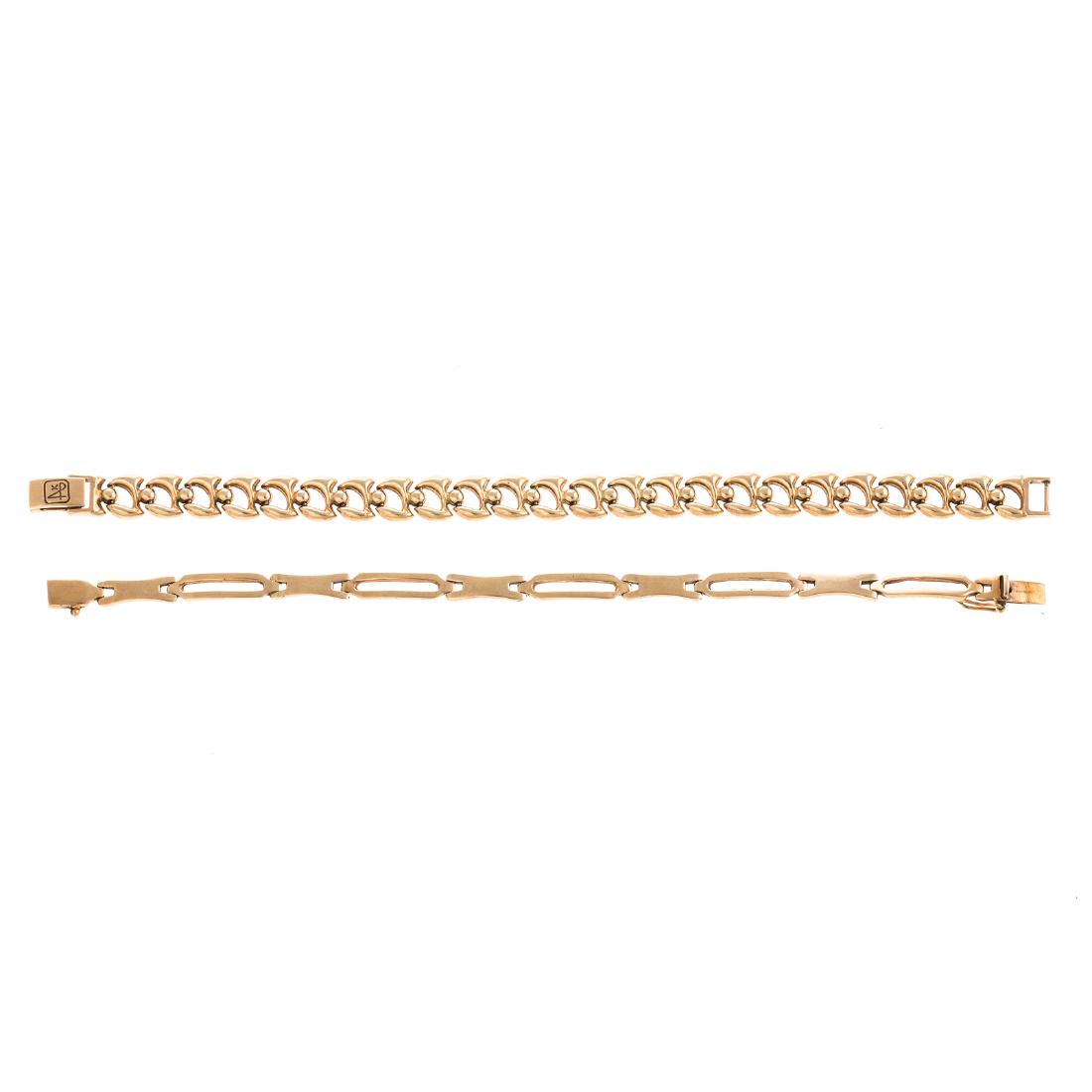 A Pair of Ladies 14K Link Bracelets: 1) 14K yellow gold high polished open link bracelet, fold over clasp, 7.5 in. L and 2) 14K yellow gold elongated open link bracelet, box clasp with figure 8 safety, 7.25 in. L, 27.3 grams tw